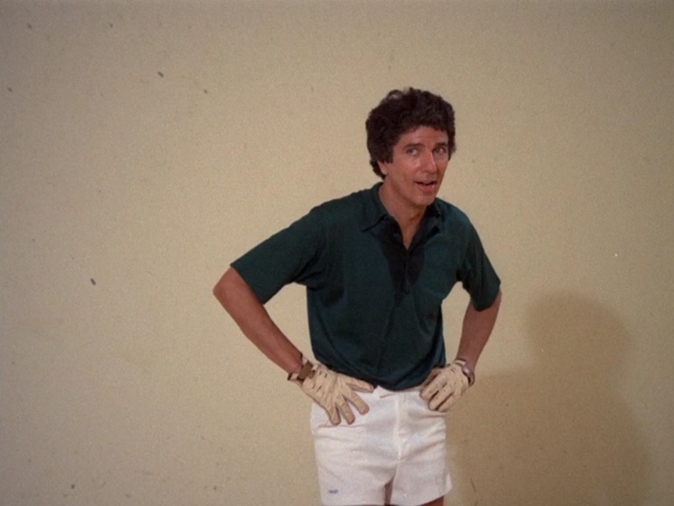 Bert Convy, a middle aged white man with dark brown curly hair wearing a dark teal polo shirt and white shorts. He's sweaty from playing handball.