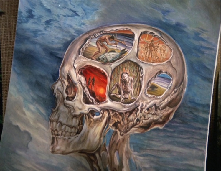 A painting of a skull bursting from the ground. The skull has five compartments depicting different scenes: a withered figure in a sugar cane field; a couple looking out at a red sunset with storm clouds; a hunter standing on a beach holding a spear over a large fish bearing a carved heart with the initials CH + MA; a school dance with everyone on puppet strings; a house with an ocean in the distance.