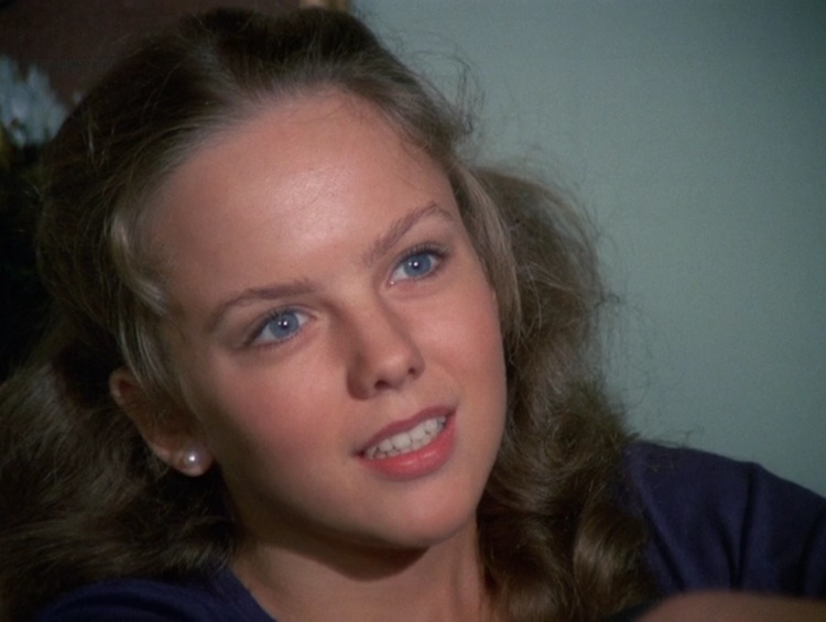 Linda Purl as Ruth Martin, a teenage white girl with long, curled blonde hair pulled back, and blue eyes.